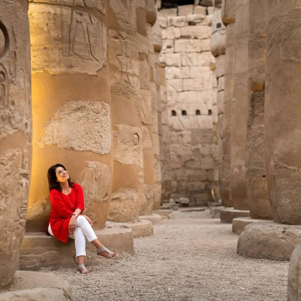 A-wonderful-photo-of-a-tourist-sitting-inside-the-hypostyle-hall-at-Karnak-Temple.