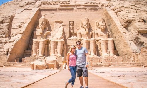 a-stunning-shot-of-a-couple-in-front-of-the-facade-of-the-great-temple-of-abu-simbel-in-aswan